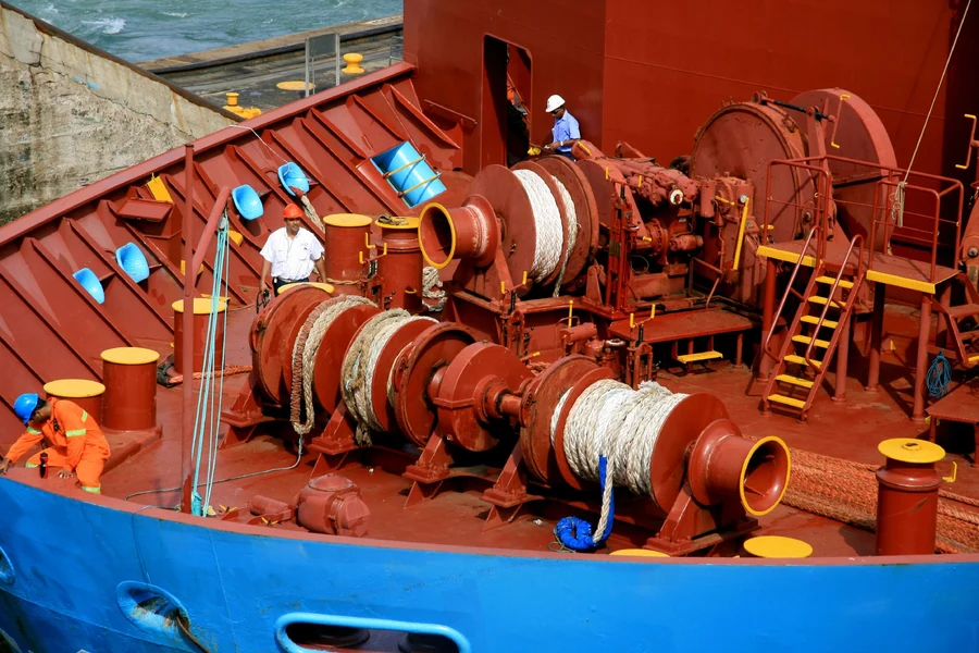 Forecastle detail of a container ship passing through the Panama Canal.Working and waiting